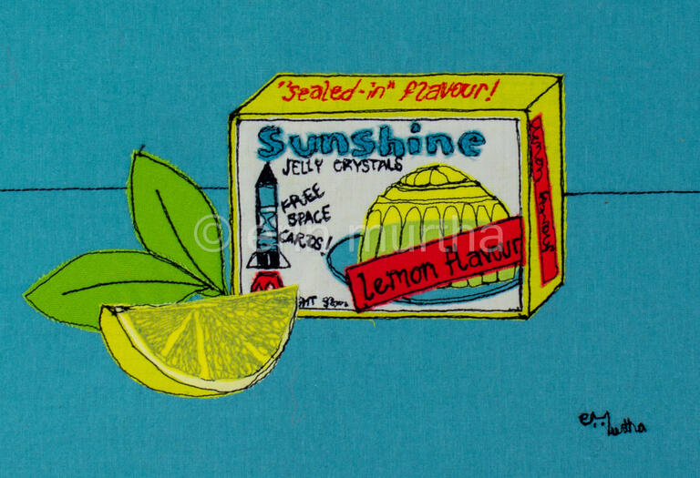 A packet of lemon jelly crystals re-created in 2D in fabric and thread